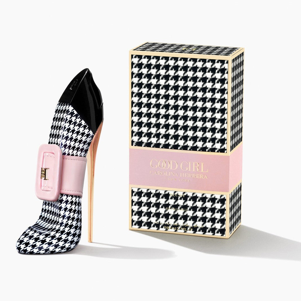 Black and white checkered high-heeled shoe with pink buckle next to its packaging box on a white background